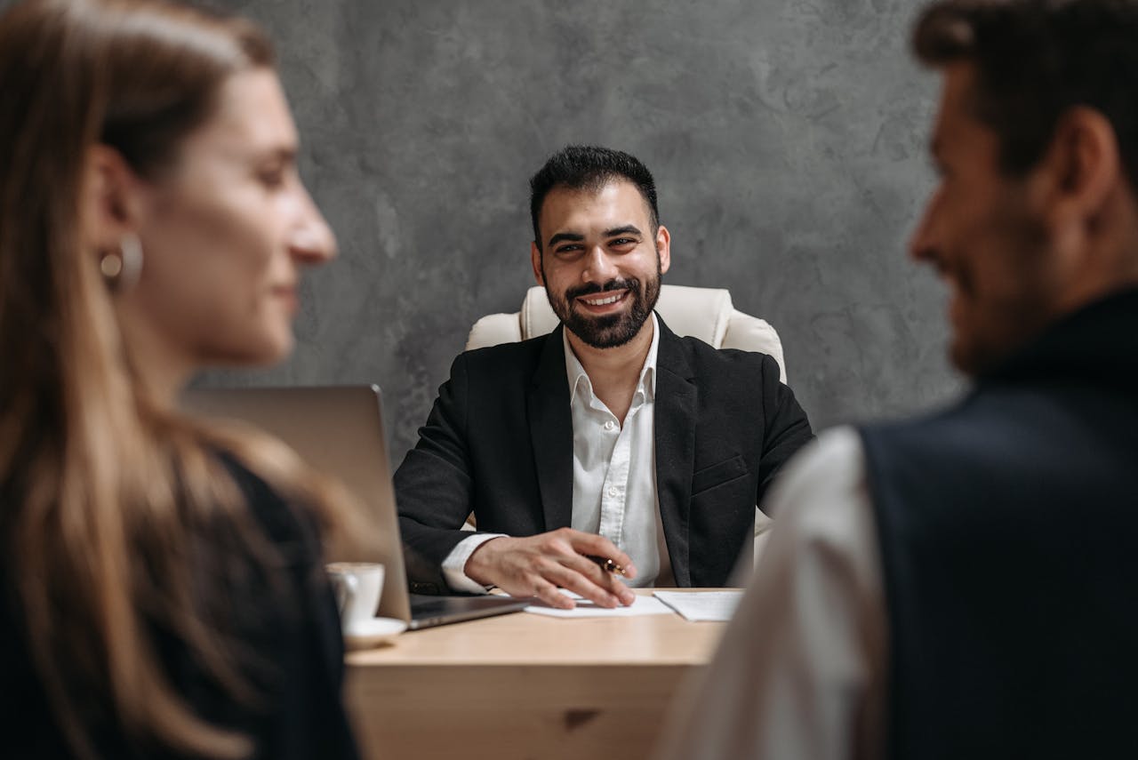 Business professional meeting with clients in a modern office setting. Ideal for corporate themes.